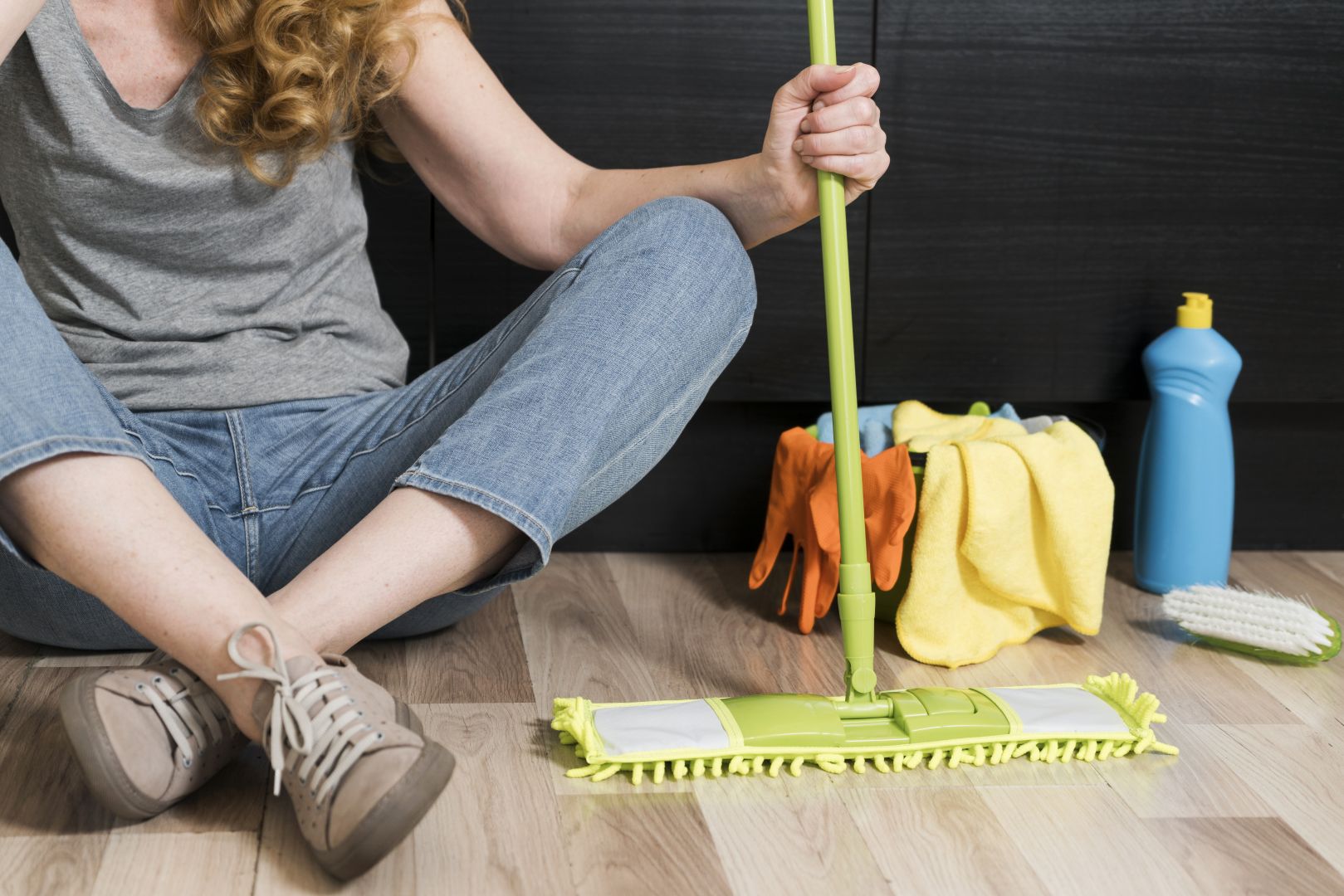 image of a women holing mop for home cleaninfg